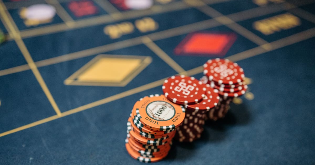 Stacked casino chips on a vibrant roulette table, symbolizing chance and gaming excitement.