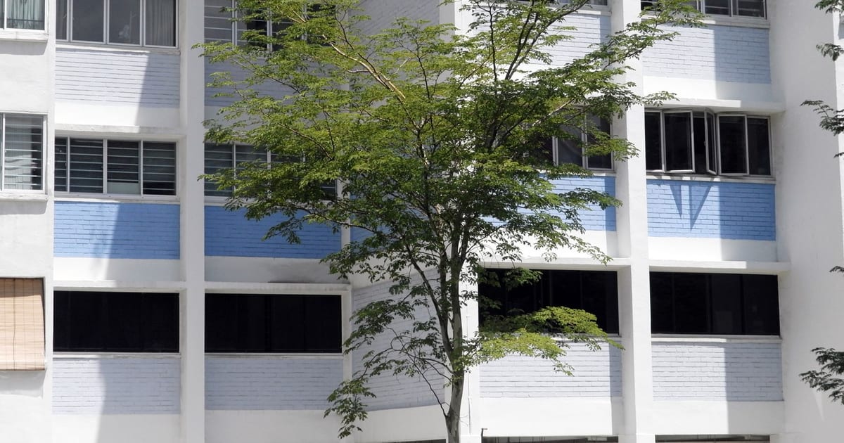 Modern residential building exterior with greenery in Singapore.