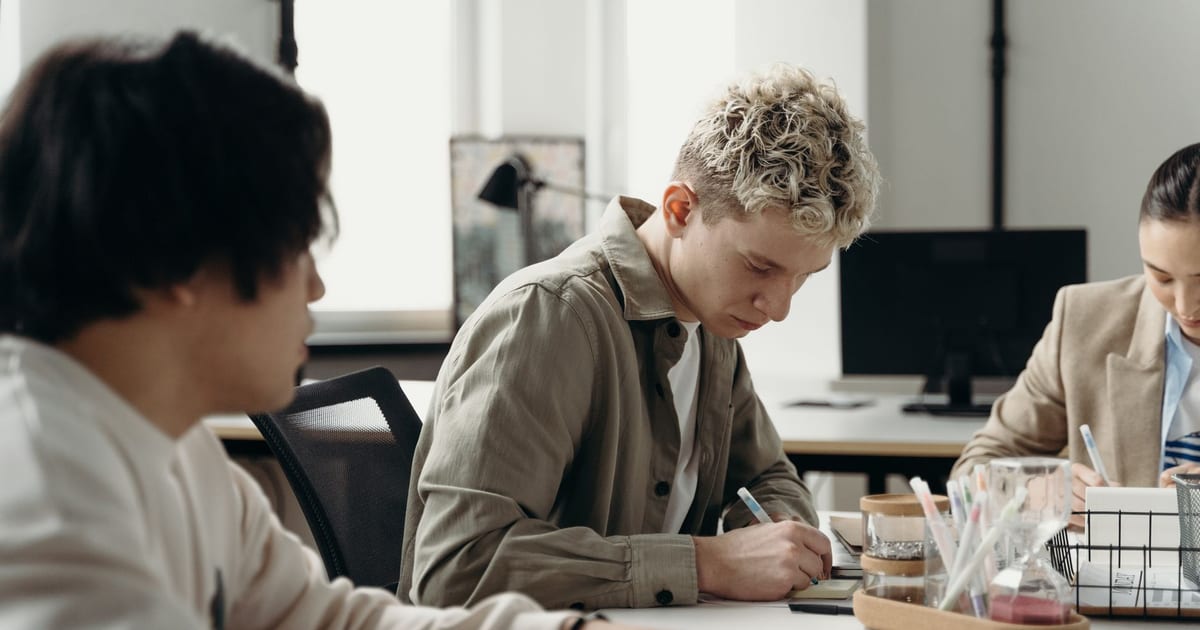 A diverse group of young professionals brainstorming in a contemporary office environment.