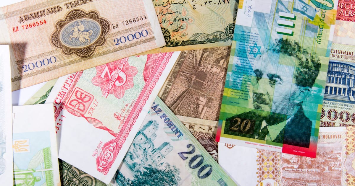 Colorful assortment of international paper currencies from various countries in a flat lay.