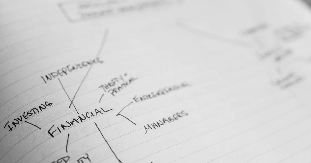 Detailed shot of a financial mind map with handwritten text on paper.