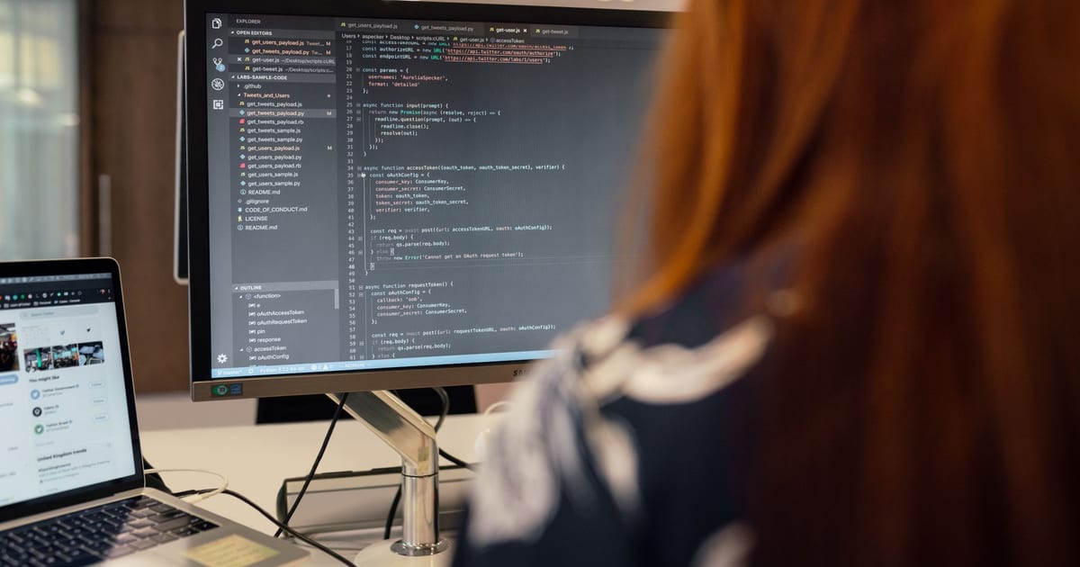 A female engineer works on code in a contemporary office setting, showcasing software development.