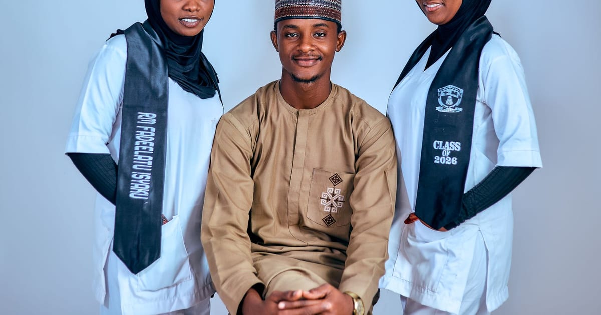 Three students in traditional and graduation attire posing for a portrait.